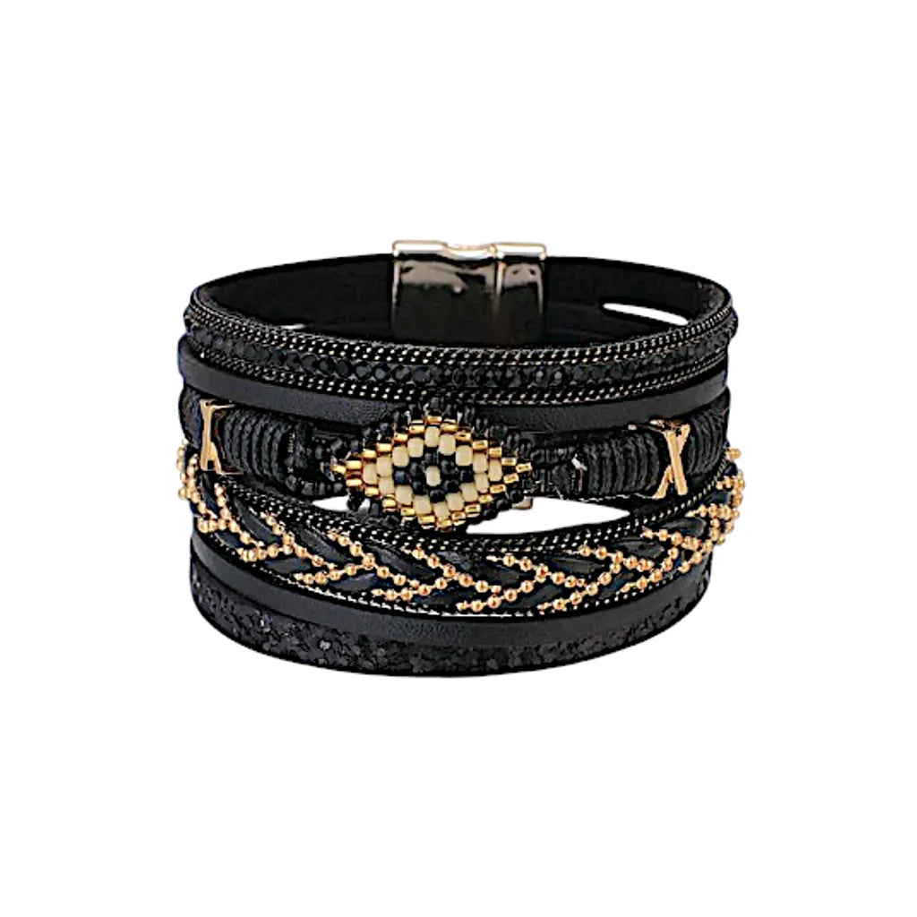 Bracelet Ćil du Chaman en cuir microfibre noir, multi-rangs avec perles, strass scintillants et motif Ćil central, fermoir magnĂ©tique, style ethnique amĂ©rindien.