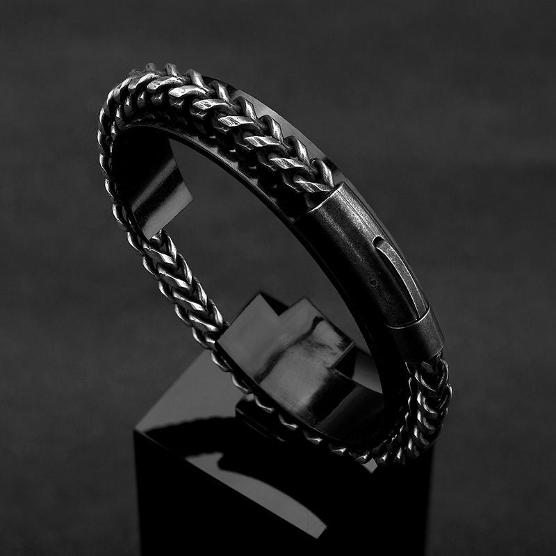 Bracelet biker avec chaîne à maillons cubains de 6 mm en acier inoxydable posé sur un socle en forme de cube de couleur noir brillant - coloris chaîne cubaine argent vieilli