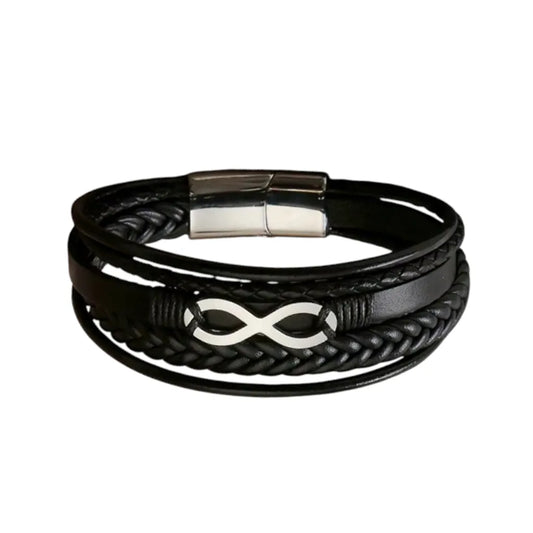 Plan large du bracelet Infini argenté. Le cuir structuré noir multi-rangs met en valeur le fermoir magnétique en acier inoxydable argenté poli sur fond blanc.