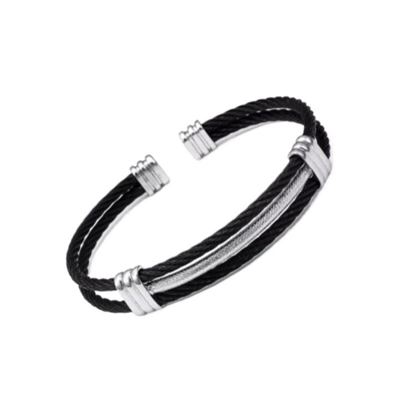 Bracelet manchette avec câble torsadé en acier inoxydable - jonc homme dressé légèrement en biais sur un plan au fond blanc - couleur Argent et noir