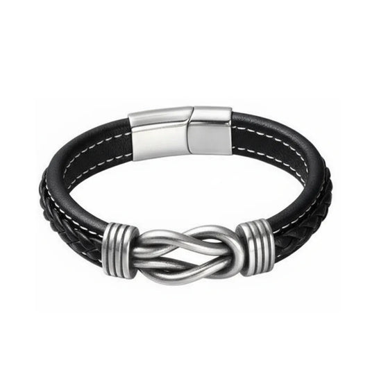 Packshot fond blanc. Le bracelet Noxus cuir noir tressé avec nœud entrelacé en acier poli argenté. L'essence du lien indissociable.