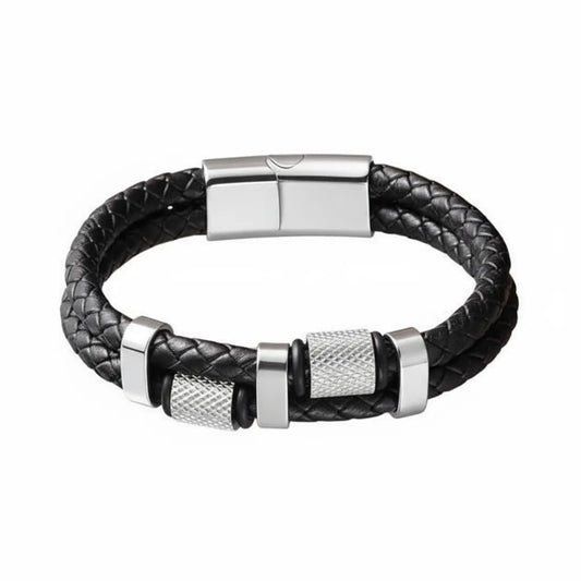 Packshot fond blanc. Le bracelet Talon cuir tressé noir et ses cylindres moletés en acier inoxydable poli. Le symbole de la précision mécanique et du grip industriel.