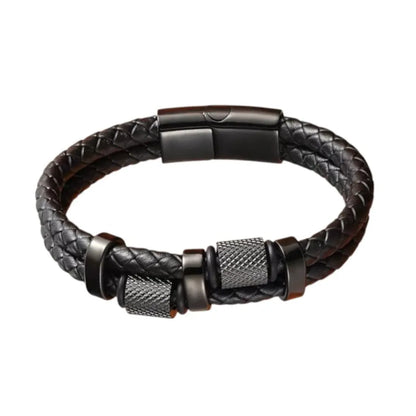 Gros plan finition exclusive. Le bracelet Talon cuir tressé noir et ses cylindres moletés en acier noir mat. L'esthétique brute de la mécanique de précision.