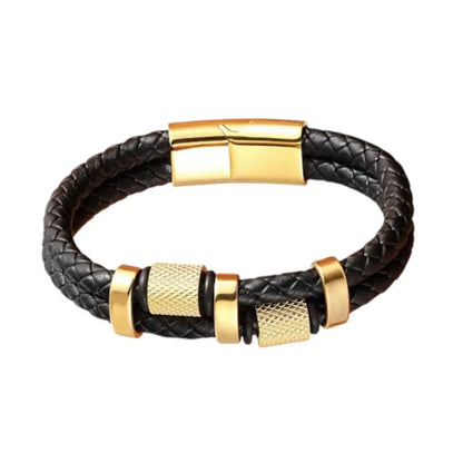 Vue produit premium. Le bracelet Talon à double cuir tressé avec ses cylindres moletés dorés et bagues ovales. Le fermoir magnétique est assorti à la finition.