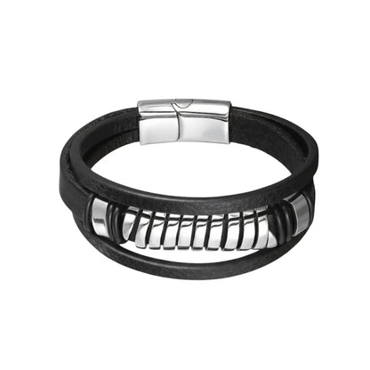 Packshot fond blanc. Le bracelet Torus multi-rangs avec ressort acier poli. La torsion visuelle au cœur du cuir souple noir.
