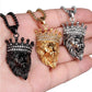 Trois colliers couronnes avec chaine et pendentif roi lion présenté a plat sur la paume de la main d'un homme - acier inoxydable -couronne royale pavée de zircone blanc - un modèle, trois coloris, noir, or et argent